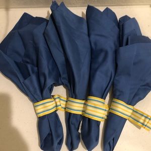 Four cotton blue napkins from Crate & Barrel with matching napkin rings